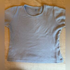 Brandy Melville Girls Light Blue Short Sleeve Top with Perforated Heart Pattern.